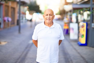 Senior handsome man smiling happy and confident. Standing with smile on face at town street