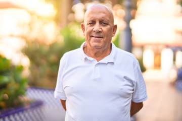 Senior handsome man smiling happy and confident. Standing with smile on face at town street