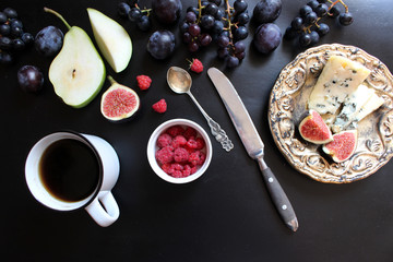 fruits, berries, cheese dor battle. On a black background. Flat lay concept.