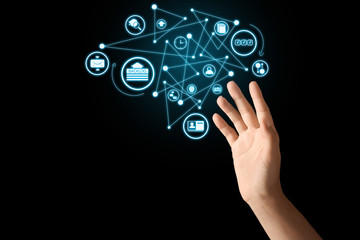 Young woman using virtual screen on dark background