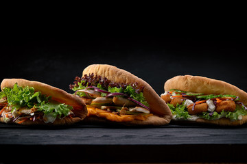 Closeup three different Appetizing sandwiches or burgers on wooden background