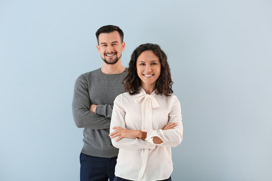 Portrait of young business people on color background