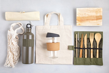 Zero waste kit. Set of eco friendly bamboo cutlery, mesh cotton bag, reusable coffee tumbler and water bottle. Sustainable, ethical, plastic free lifestyle.