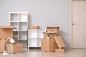 Cardboard boxes with belongings in new flat on moving day