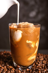 Preparing of cold coffee on dark background