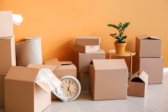 Cardboard boxes with belongings in new flat on moving day