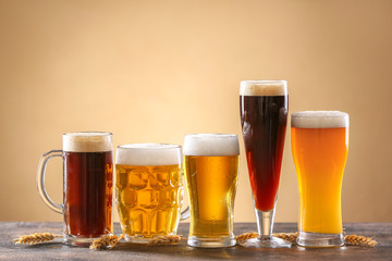 Glasses of different tasty beer on table