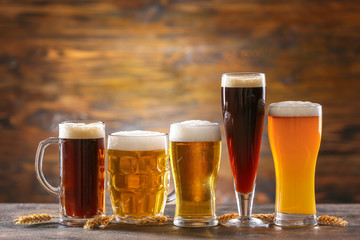 Glasses of different tasty beer on table