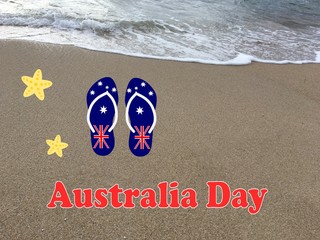 Beach with ocean waves, flip flops and a starfish as a symbol of Australia Day which is celebrated every January 26