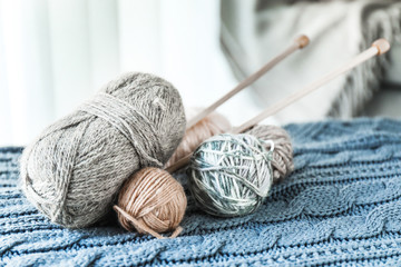 Fototapeta na wymiar Knitting yarn and needles on plaid at home