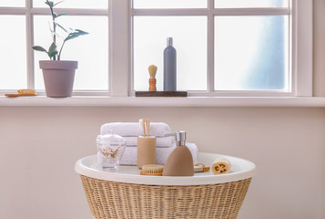 Body care cosmetics with accessories on table in bathroom