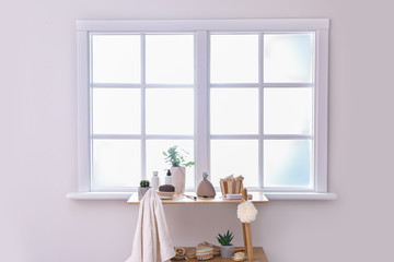 Body care cosmetics with accessories on rack in bathroom