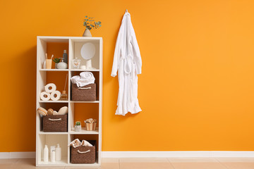 Body care cosmetics with accessories on rack in bathroom