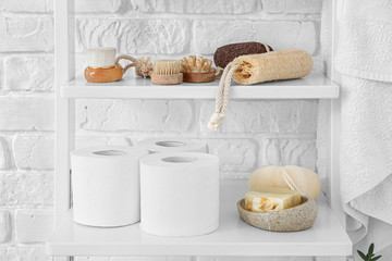 Body care cosmetics with accessories on shelves in bathroom