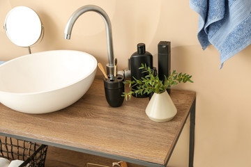 Body care cosmetics with accessories near sink in bathroom