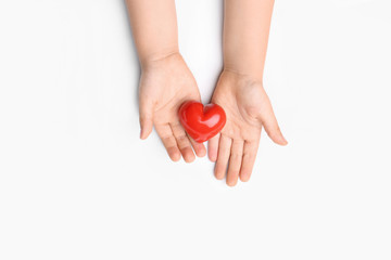 Child hands with red heart on white background. Cardiology concept