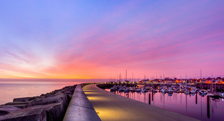 Amazing sky on sunrise at Greystones yacht marina or harbour with anchored boats and long...