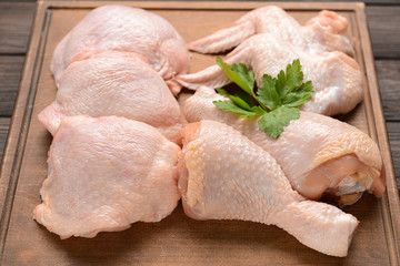 Raw chicken meat on wooden board