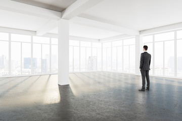 Young businessman standing in modern interior