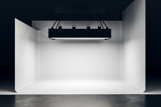 Photo studio with lighting equipment and white background