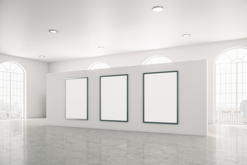 Bright gallery interior with three white banner