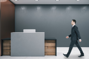 Businessman walking in office lobby interior