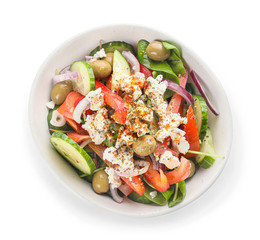 Bowl of tasty Greek salad on white background