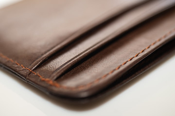 brown leather wallet on white background, purse close-up
