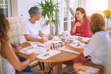 Young beautiful girl smiling happy and confident sitting dinking cup of coffee at terrace