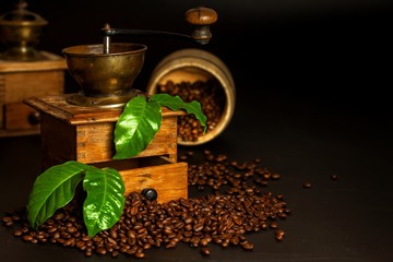 Coffee beans and a wooden grinder. Old coffee grinders. Healthy drink. Healthy drink. Grinding coffee.