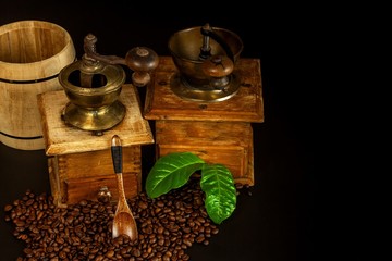 Coffee beans and a wooden grinder. Old coffee grinders. Healthy drink. Healthy drink. Grinding...