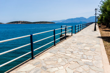 Coastal walking path with lamp, Agios Nikolaos, Crete, Greece