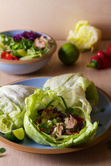 Stuffed iceberg lettuce cabbage leaves with chicken and vegetables. Wraps pockets of lettuce with chicken