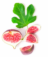 Sliced fresh fig with a fig leaf isolated on white background.
