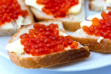 Sandwiches of bread and butter with red caviar. Bread and butter with red caviar. Gourmet food.