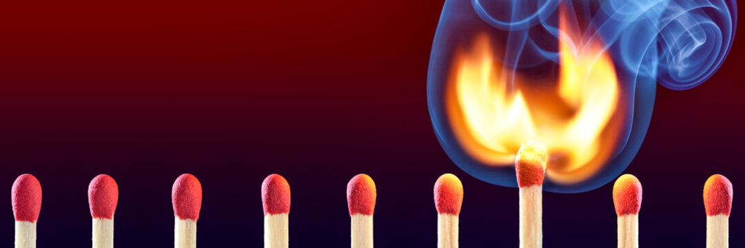 Row Of  Matchsticks With One Bursting Into Flames - Leadership Concept
