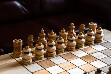 Wood chess pieces on board game. brown vintage background. Chess game close-up. Chess requires careful planning, time management, and the motivation to act. Game concept.