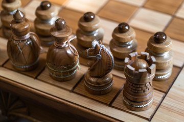 Wood chess pieces on board game. brown vintage background. Chess game close-up. Chess requires careful planning, time management, and the motivation to act. Game concept.