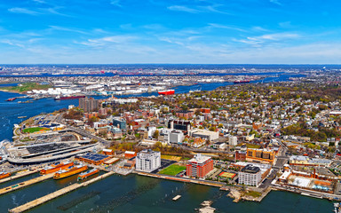 Aerial view of Dry Dock and Repair and Port Newark and Global international shipping containers, Bayonne, New Jersey. NJ, USA. Harbor cargo. Staten Island with St George Ferry terminal, New York City