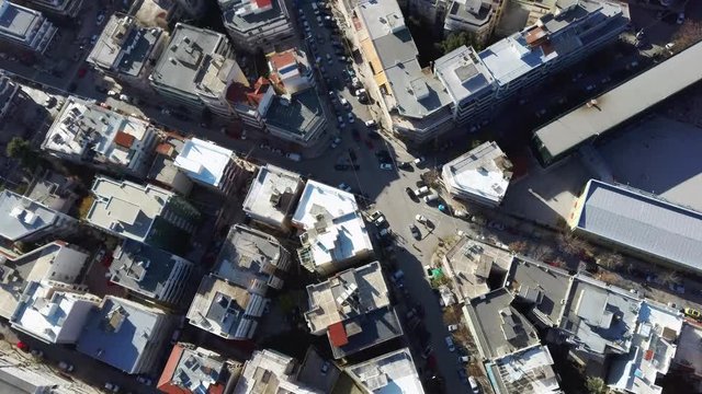 Aerial view of urban environment with buildings and roads with cars, Thessaloniki Greece, moving up and forward by drone