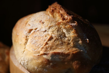 Wheat fresh bread on a wooden table. Bakery.