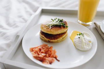 Close up of nutritious and tasty healthy breakfast in bed on tray