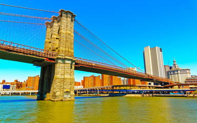 Brooklyn bridge across East River, New York, USA. It is among the oldest in the United States of...