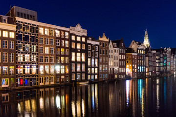 Traditional Dutch buildings at Damrak at night, Amsterdam, Netherlands