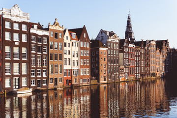 Naklejka premium Traditional Dutch buildings at Damrak in Amsterdam, Netherlands