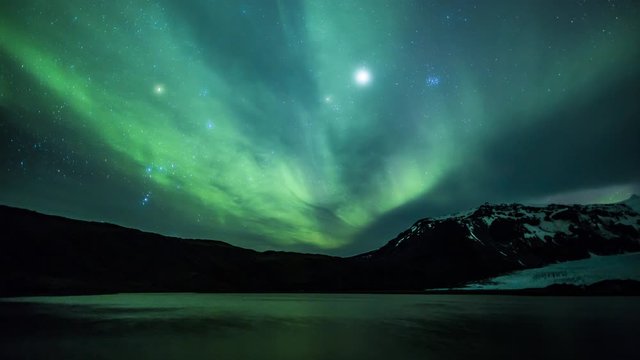 4K Aurora Borealis over a glacier lagoon in the arctic