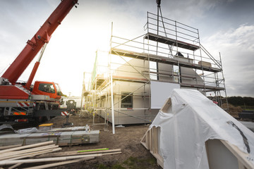 Construction of a Single Family Home with the Help of a Crane - 313499413