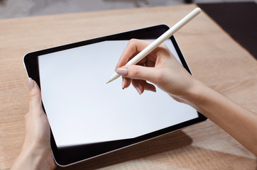 Girl using stylus on tablet to draw