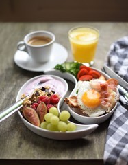 Colorful, healthy and tasty breakfast ingredients  on wooden table