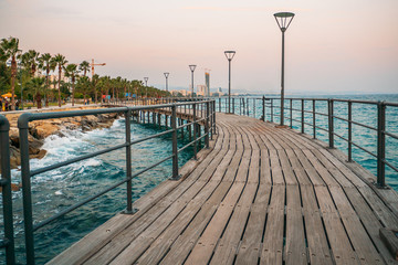 Cyprus. Limassol. Wooden pier on promenade and Mediterranean Sea. Travels to Cyprus concept.